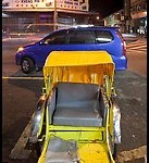 Rickshaw and auto at night. George Town, Penang, Malaysia